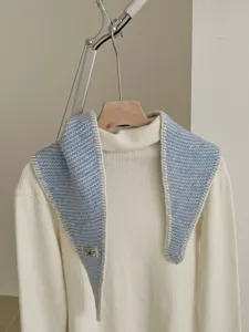 Detailed view of the knitted contrast-edge diamond scarf showing soft texture and cozy fit.