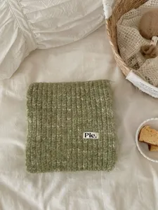 Detailed view of the retro variegated green knitted winter scarf showcasing soft plush texture.