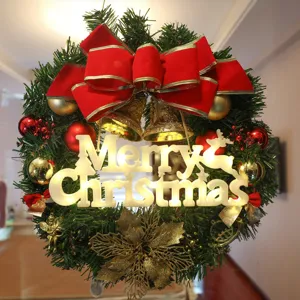 Christmas wreath with glowing Merry Christmas letters, red bow and festive holiday decor.