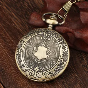 Close-up of vintage bronze quartz pocket watch with intricate shield and floral carvings.