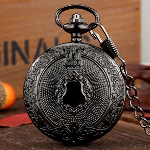 Detail view of vintage black gunmetal quartz pocket watch with engraved shield and chain.