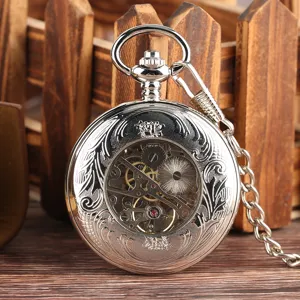 Detailed view of silver mechanical pocket watch with exposed gears and skeleton design.