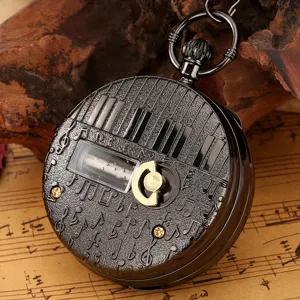 Vintage black pocket watch with piano keys and music box mechanism. Retro style gift.