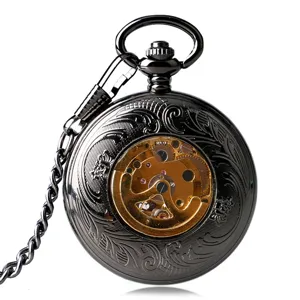Close-up detail of vintage black mechanical pocket watch with ornate hollow skeleton dial design.