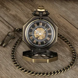 Detailed view of vintage mechanical pocket watch with skeleton dial and octagonal antique case.