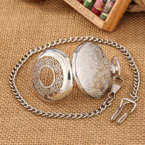 Vintage silver hollow carved quartz pocket watch with matching chain and secure clip.