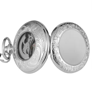 Detailed view of silver vintage mechanical pocket watch, featuring ornate engraved floral patterns.