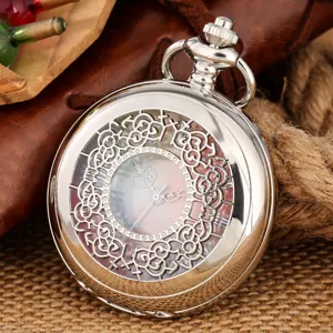 Vintage silver hollow quartz pocket watch with crystal rhinestone dial and floral cover.