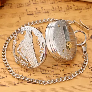 Vintage hollow steam train music pocket watch with chain, classic quartz timepiece detail.