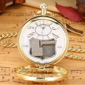 Close-up of vintage gold pocket watch with visible mechanical music box movement and chain.
