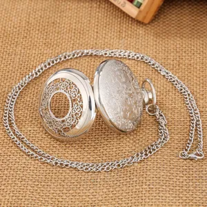 Vintage silver hollow quartz pocket watch with long chain rustic burlap background detail shot