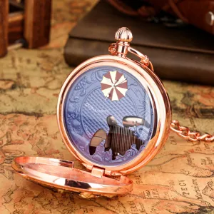 Vintage rose gold pocket watch with music movement and unique mechanical dial design.