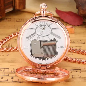 Vintage rose gold mechanical musical pocket watch with visible movement and chain detail
