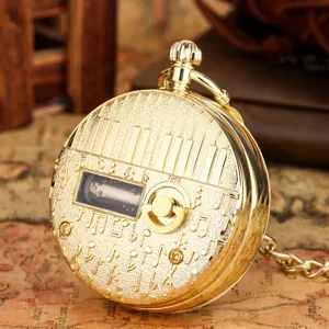 Vintage gold pocket watch with piano keys and music notes engraving, mechanical music box gift.