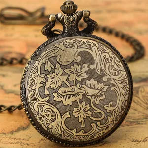 Close-up of vintage bronze pocket watch with intricate floral carving and chain detail.