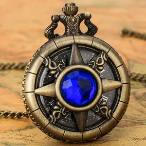 Closeup view of vintage bronze pocket watch featuring a blue crystal center and Roman numeral dial.
