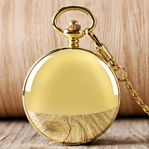 Close-up detail of the classic golden vintage mechanical pocket watch with attached chain.