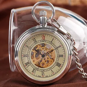 Vintage mechanical pocket watch detail shot, skeleton dial with Roman numerals and metal chain.