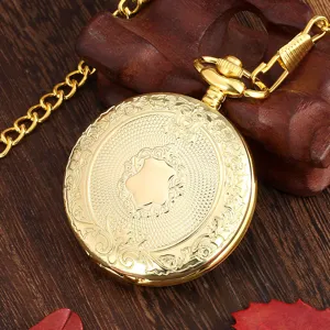 Close-up detail of vintage gold quartz pocket watch with exquisite carved shield pattern and chain.