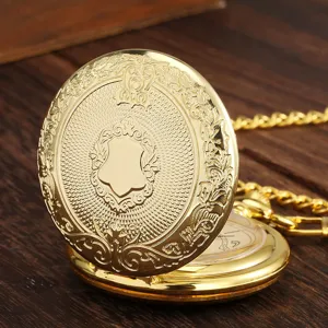 Detailed close-up of vintage gold quartz pocket watch featuring ornate engraved shield.