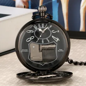 Vintage black pocket watch with visible mechanical music box movement and classic dial design.