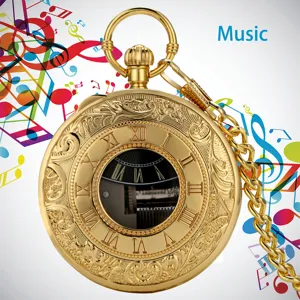 Vintage gold mechanical music pocket watch with detailed carved dial and matching chain.