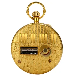 Golden mechanical music pocket watch detail with piano keys and notes engraving, vintage wind-up.