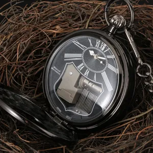 Vintage black quartz pocket watch with mechanical music movement displayed on rustic twig background.
