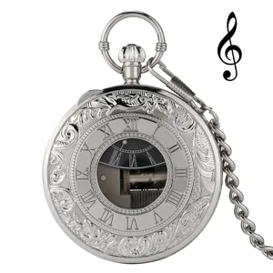 Vintage silver mechanical pocket watch with music box movement and ornate engraved case.