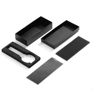 Black rectangular watch gift box detail shot, showing empty paper box and foam insert.
