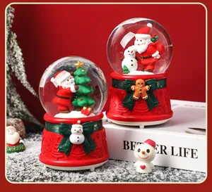 Christmas snow globe night light music box with Santa snowman figurines for holiday tabletop decor.