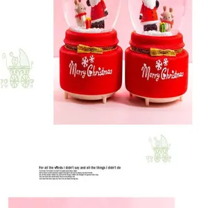 Christmas snow globe music box with glowing red base and Santa Claus figurine for holiday gifts.