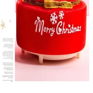 Red Christmas velvet storage stool with gold ribbon and festive print detail view