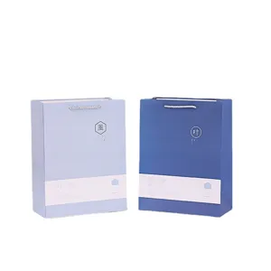 Paper gift bags with handles, blue shopping packaging bags for retail, stylish present carriers.
