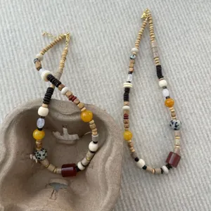 Asymmetric colorful beaded necklace featuring natural jade and wood beads for a unique island style.