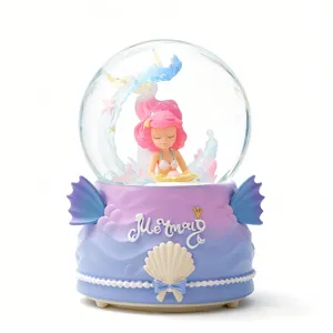 Detalle bola de nieve sirena, figura de pelo rosa y decoración de escritorio luminosa.