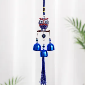 Blue owl evil eye metal wind chime hanging ornament with bells and tassel decoration.