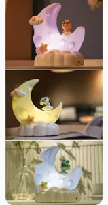 Cute cartoon moon night light with adorable animal figures for bedroom bedside table decor.