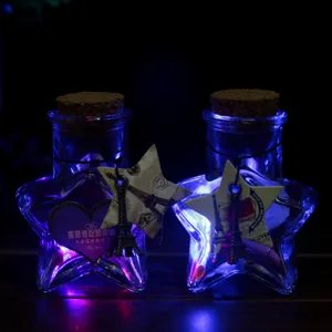 Star-shaped glass wishing bottle with LED lights, cork stopper and Eiffel Tower charm for gifts.