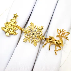 Gold Christmas napkin rings detail, featuring tree snowflake elk designs for holiday table.