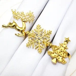 Gold Christmas napkin rings set featuring elk, snowflake and tree designs for table decor.