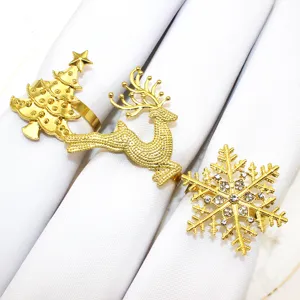 Detailed close-up of gold Christmas napkin rings featuring tree, deer and snowflake designs.