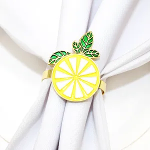 Gold alloy yellow lemon napkin ring with green leaves detail, elegant table decor for hotel.