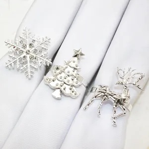 Silver Christmas napkin rings set featuring snowflake, tree and reindeer designs for table decor.