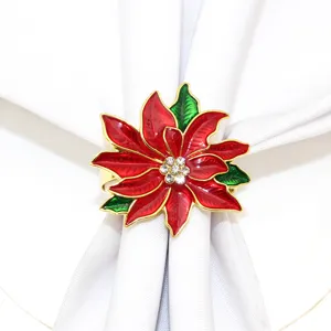 Close up view of the elegant Christmas poinsettia metal napkin ring with red and green paint.