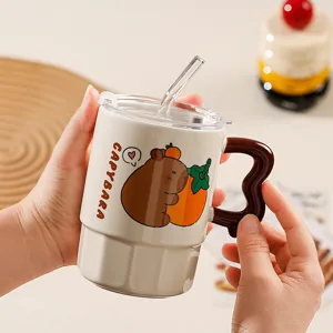 Close-up detail of the cute capybara ceramic mug with wavy brown handle, straw and clear lid.