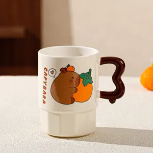 Cute capybara ceramic coffee mug with unique handle and persimmon graphic for home use.