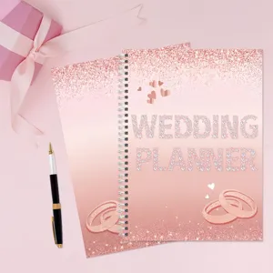 Rose gold wedding planner notebook with diamond text design, elegant wedding organizer book.