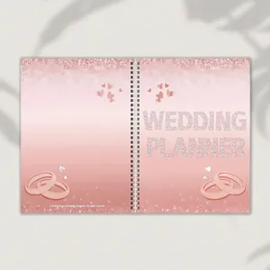 Rose gold wedding planner notebook with spiral binding and elegant glitter cover design for planning.