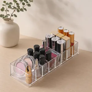Clear acrylic makeup organizer with multiple compartments for desktop cosmetic storage.
